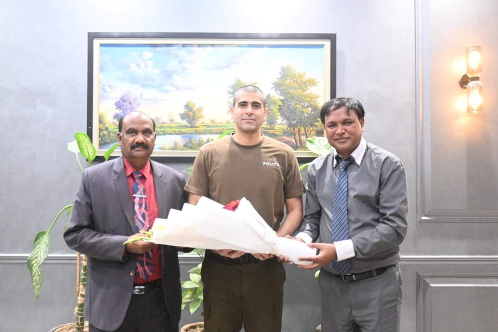 Shahzad Lawrence and Rev. Arif Siraj are presenting flowers to Sardar Ghias Gul Khan